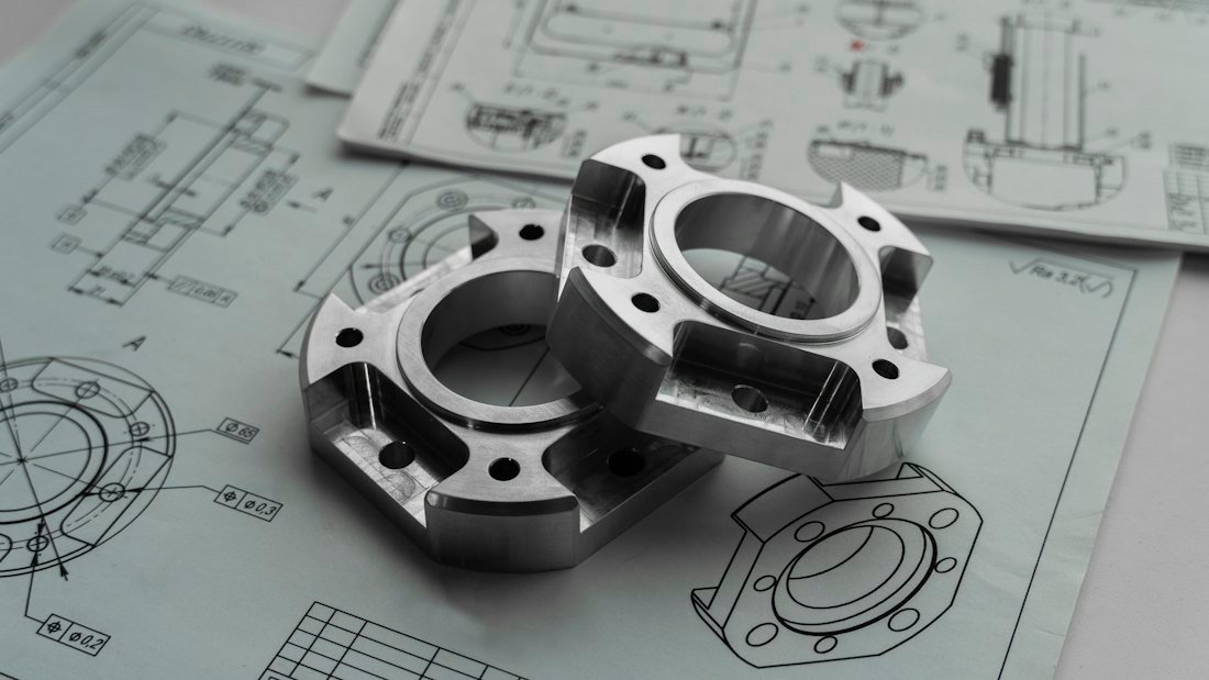 Precision machined metal parts on engineering drawings (demonstration image)